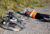 cyclist sleeping next to bicyle
